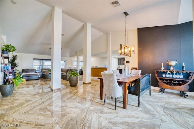 dining room featuring lofted ceiling and a notable chandelier