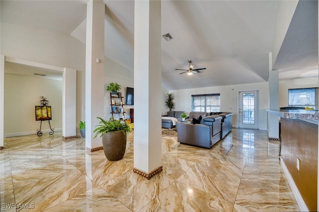 living room featuring ceiling fan and vaulted ceiling