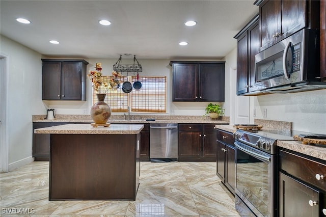 kitchen with dark brown cabinetry, sink, stainless steel appliances, and a kitchen island