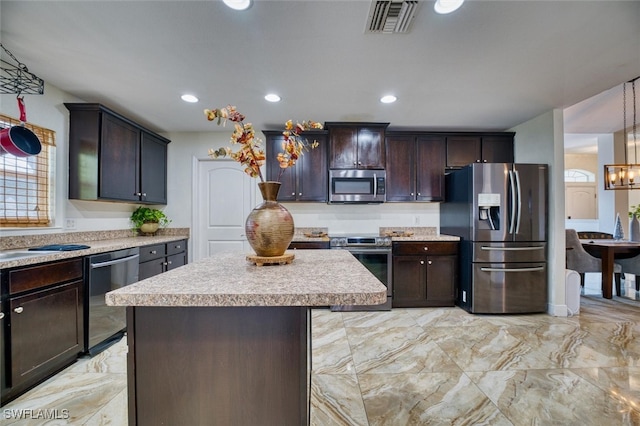 kitchen with dark brown cabinetry, stainless steel appliances, a center island, and hanging light fixtures