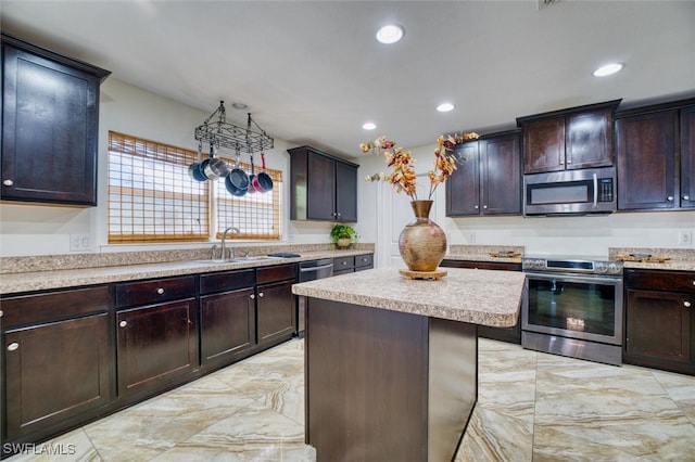 kitchen featuring stainless steel appliances, a center island, sink, and dark brown cabinets