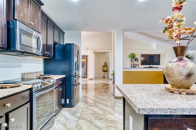 kitchen featuring a kitchen island, appliances with stainless steel finishes, and dark brown cabinetry