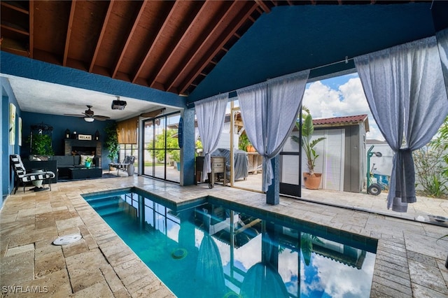 view of pool with a patio area, outdoor lounge area, and ceiling fan