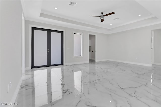 tiled empty room featuring ceiling fan, ornamental molding, french doors, and a tray ceiling