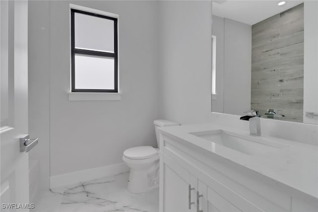 bathroom featuring tile patterned flooring, vanity, and toilet