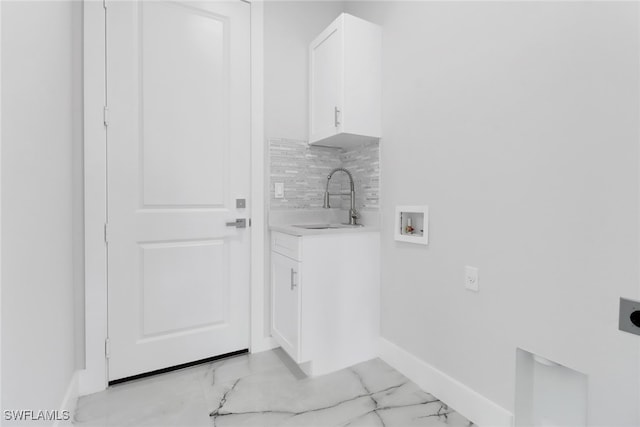 clothes washing area featuring light tile patterned floors, sink, electric dryer hookup, and hookup for a washing machine