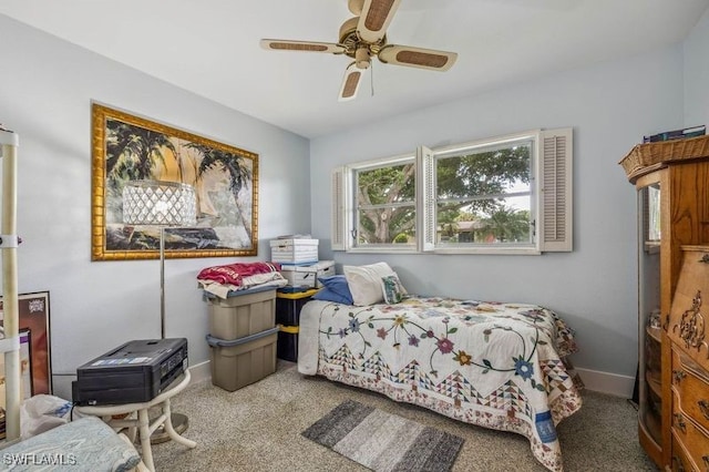 carpeted bedroom featuring a ceiling fan and baseboards