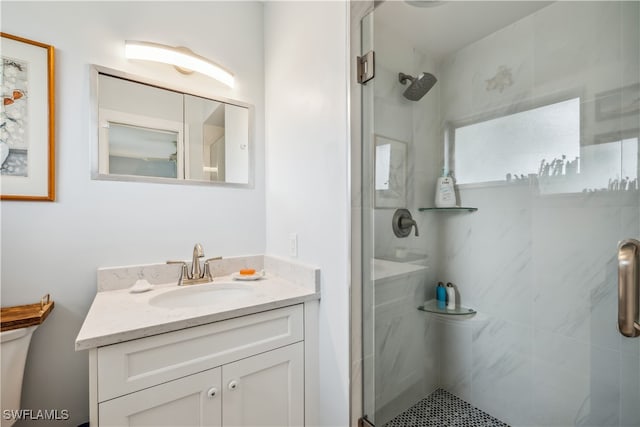 bathroom featuring a stall shower, vanity, and toilet