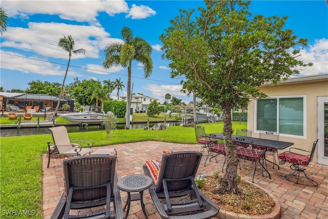 view of patio / terrace with outdoor dining space and a water view