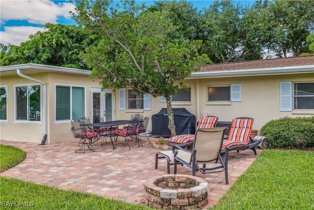 view of patio / terrace with an outdoor fire pit and area for grilling