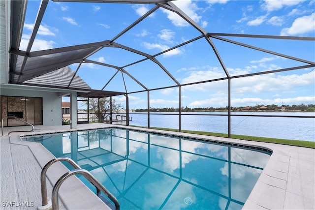 view of swimming pool featuring glass enclosure, a patio area, and a water view