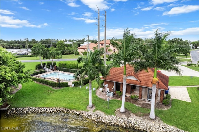 view of home's community with a yard and a water view