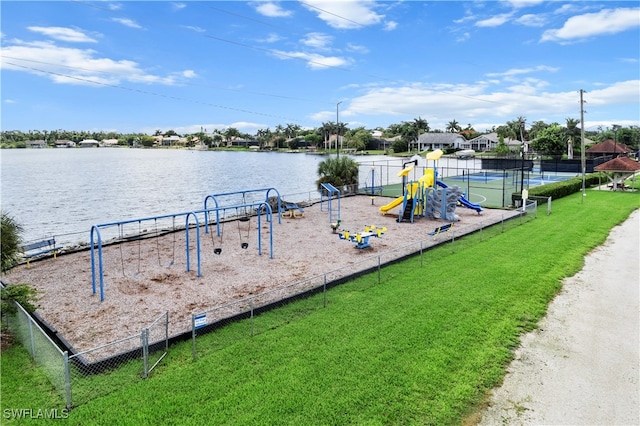 dock area featuring a playground, a lawn, and a water view