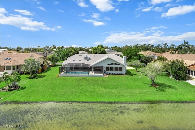 rear view of house with a lanai and a lawn