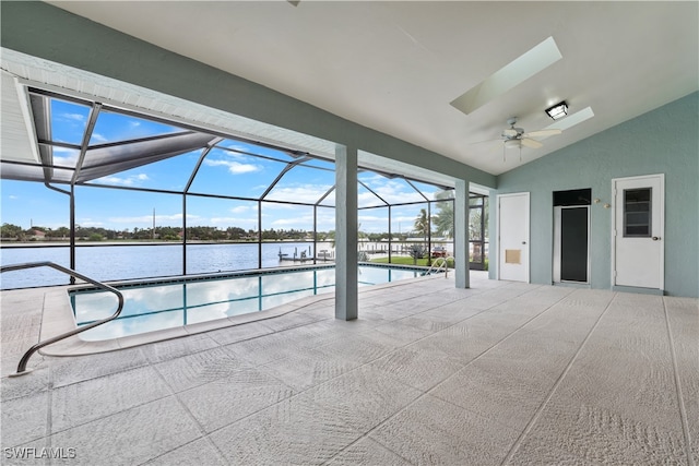 view of pool featuring a lanai, a water view, a patio area, and ceiling fan