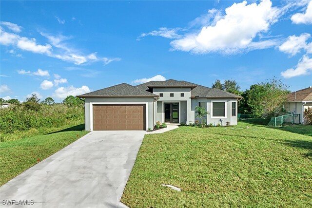 2802 63rd St W, Lehigh Acres, FL 33971 - prairie-style home featuring a garage, stucco siding, concrete driveway, and roof with shingles