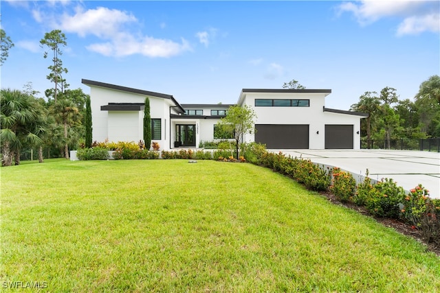 contemporary house featuring a front yard and a garage