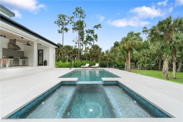 view of pool with an in ground hot tub, an outdoor kitchen, area for grilling, ceiling fan, and a patio area