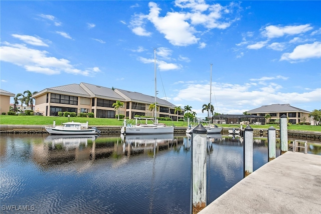 dock area featuring a water view and a lawn