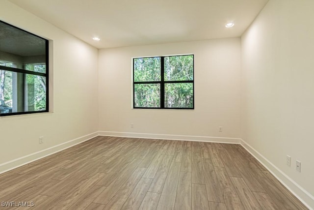 unfurnished room with light hardwood / wood-style floors