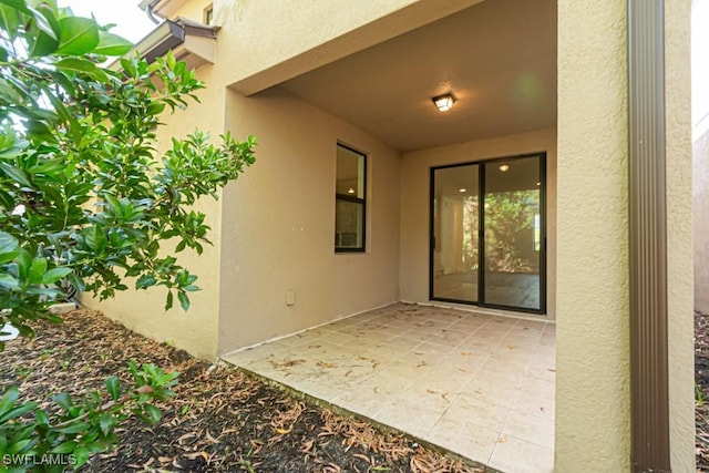 entrance to property featuring a patio area