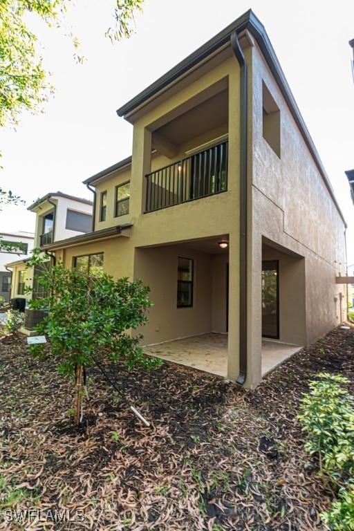 back of property with a patio area