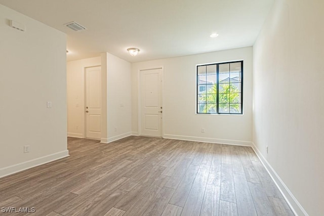 unfurnished room featuring hardwood / wood-style floors