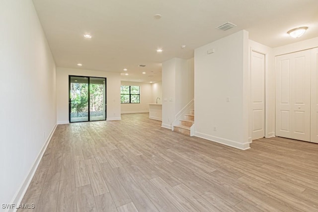 unfurnished living room featuring light hardwood / wood-style floors