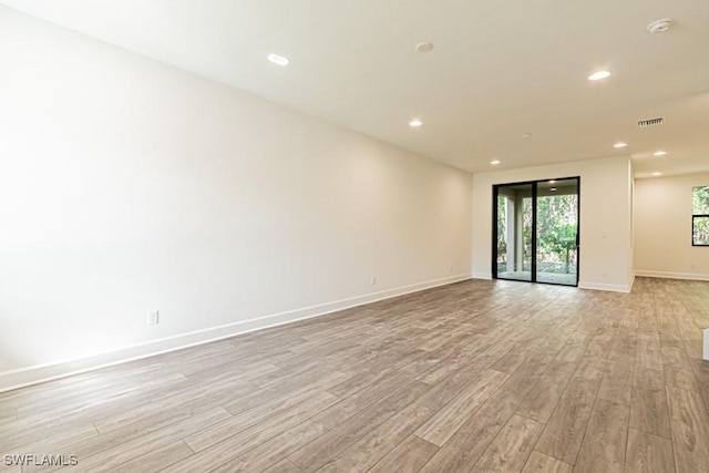 empty room with light hardwood / wood-style flooring