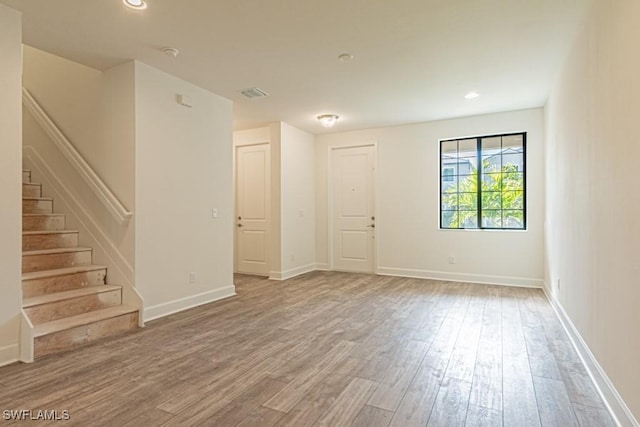 empty room with hardwood / wood-style flooring