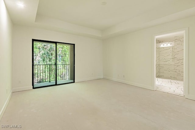 unfurnished room featuring a tray ceiling