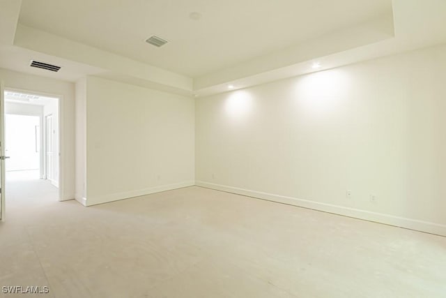 empty room with a raised ceiling