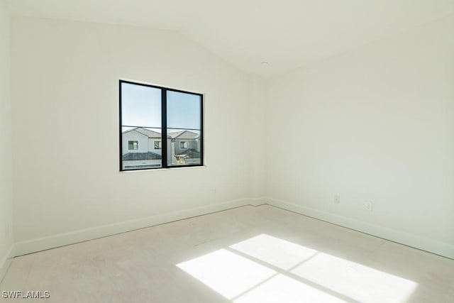 spare room with lofted ceiling