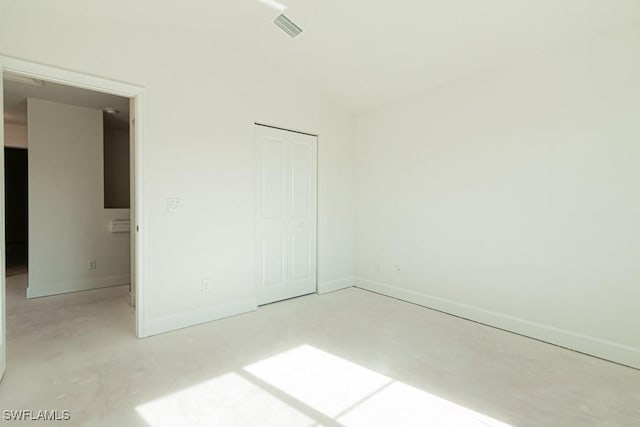 unfurnished bedroom with a closet and vaulted ceiling