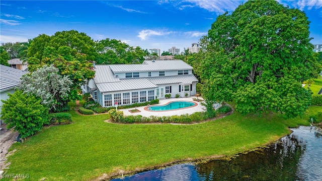 rear view of property featuring a yard and a water view