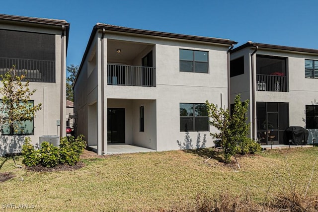 back of house with a lawn, a patio, and central AC unit