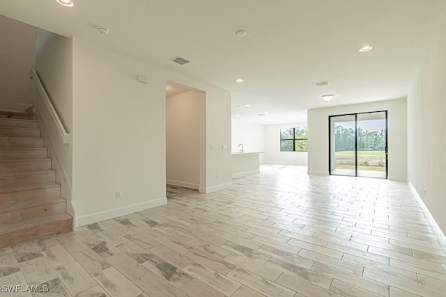 unfurnished room with light wood-type flooring