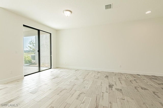 spare room with light hardwood / wood-style flooring