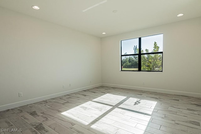 spare room with light hardwood / wood-style flooring