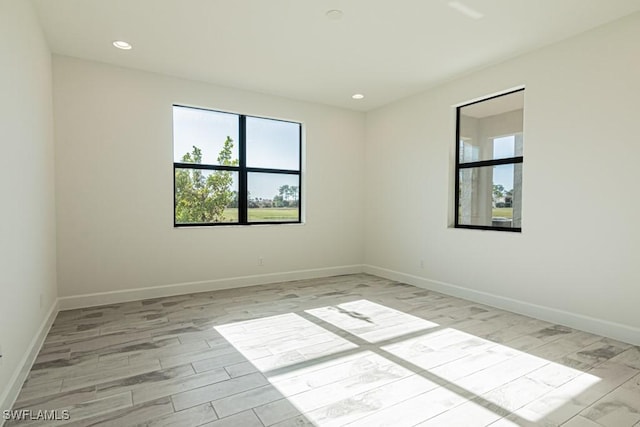 empty room with light hardwood / wood-style flooring