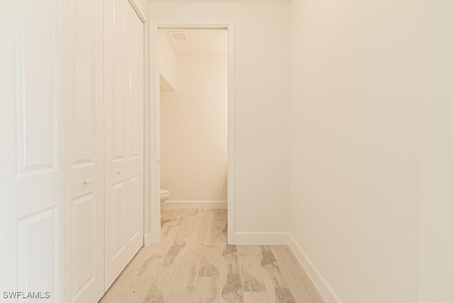 corridor with light hardwood / wood-style floors