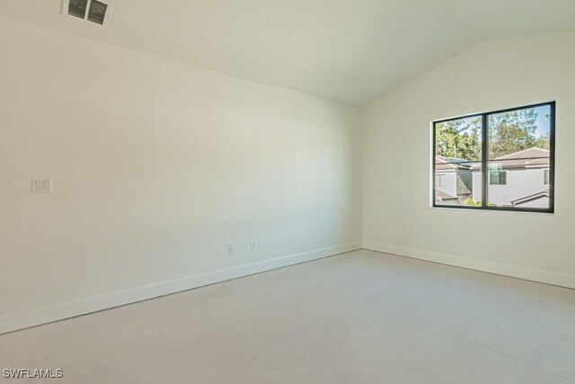 empty room with vaulted ceiling