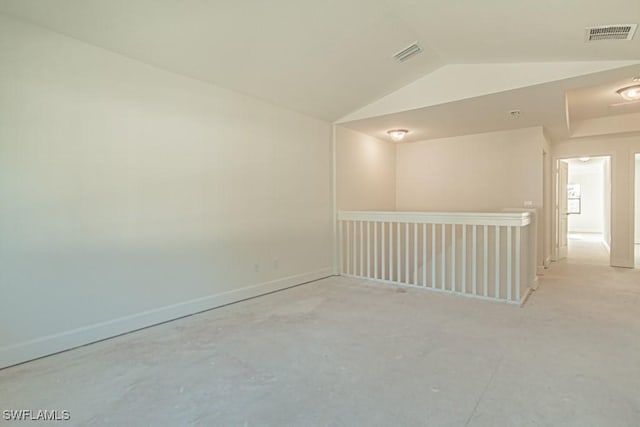 unfurnished room featuring lofted ceiling