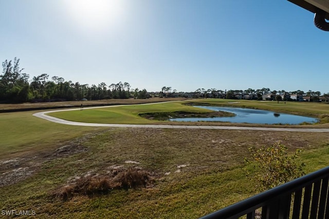 view of community featuring a water view and a yard