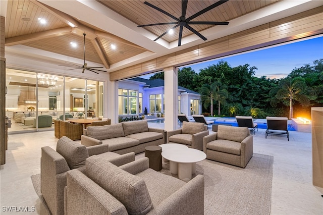 interior space with outdoor lounge area, ceiling fan, and a swimming pool