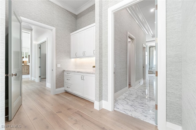 hall featuring light hardwood / wood-style floors and crown molding