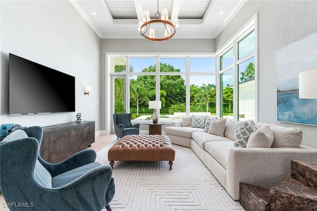 living room with a raised ceiling, plenty of natural light, and a towering ceiling