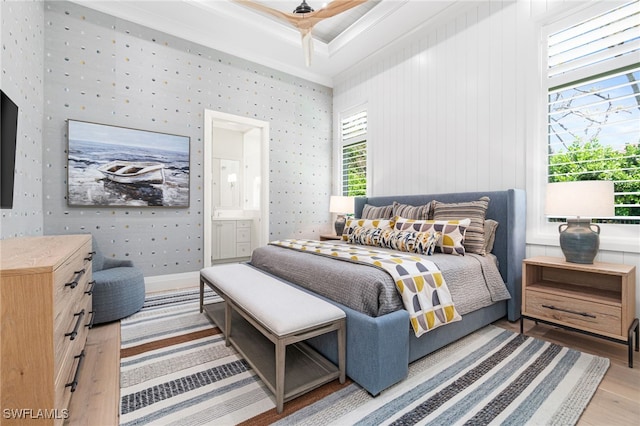 bedroom featuring ensuite bathroom, hardwood / wood-style flooring, and ceiling fan