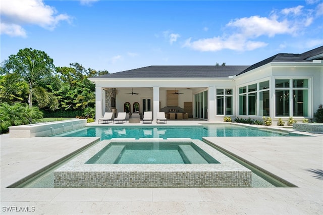 view of pool with ceiling fan, a patio, and an in ground hot tub