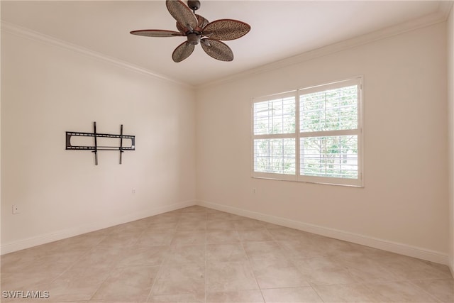 tiled empty room with ceiling fan and ornamental molding